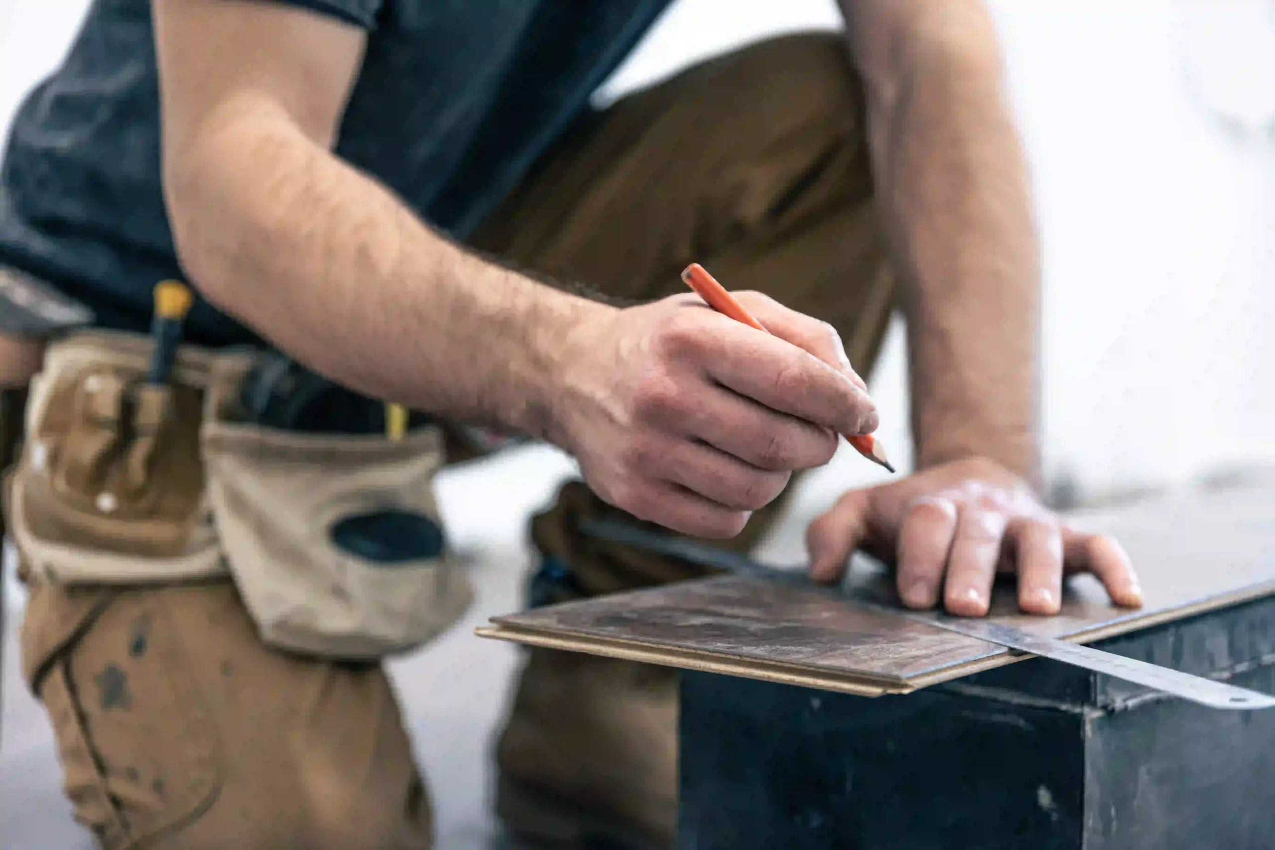 male-worker-puts-laminate-flooring-floor